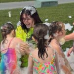 Campers are having a blast playing in the foam at the YMCA summer day camp