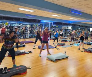 Participants in a Game Day Gains Les Mills workout at the Sinking SpringYMCA fitness studio