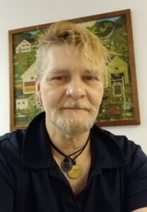 Roy, a YMCA Men’s Bridge program graduate, smiling at the YMCA of Reading and Berks County after rebuilding his life through recovery and community support.