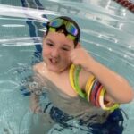 Cazden smiling in the pool during swim lessons at the YMCA of Reading and Berks County