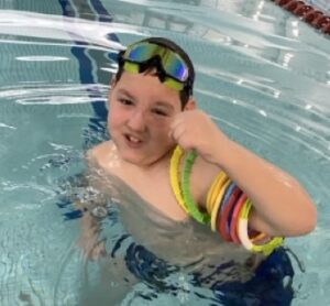Cazden smiling in the pool during swim lessons at the YMCA of Reading and Berks County