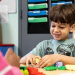 Child in Pre-K Counts program at YMCA Early Learning Center learning through hands-on classroom activities