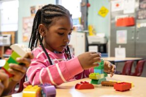 Child in Pre-K Counts program at YMCA Early Learning Center learning through hands-on classroom activities