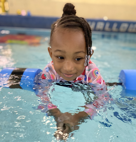 Child learning to swim at swim lessons at Reading YMCA